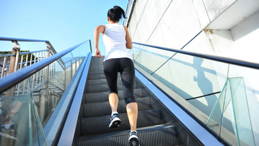 Runner athlete running on escalator stairs