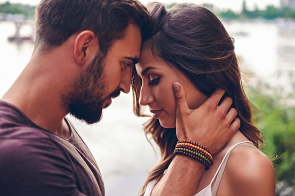 Couple touching with heads before kissing - signs a virgo man is falling in love with you