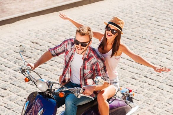 beautiful young couple riding scooter together - signs a virgo man is falling in love with you